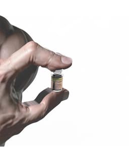 We Didn't Work For This - image 2 - close-up of hand holding a vial of steroids