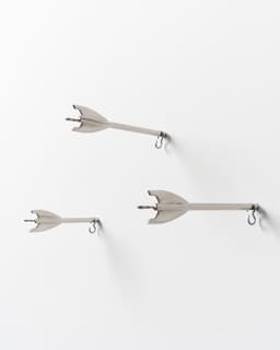 Five Brass Arrow Wall Hooks - image 8 - side view of the arrow hooks embedded in wall