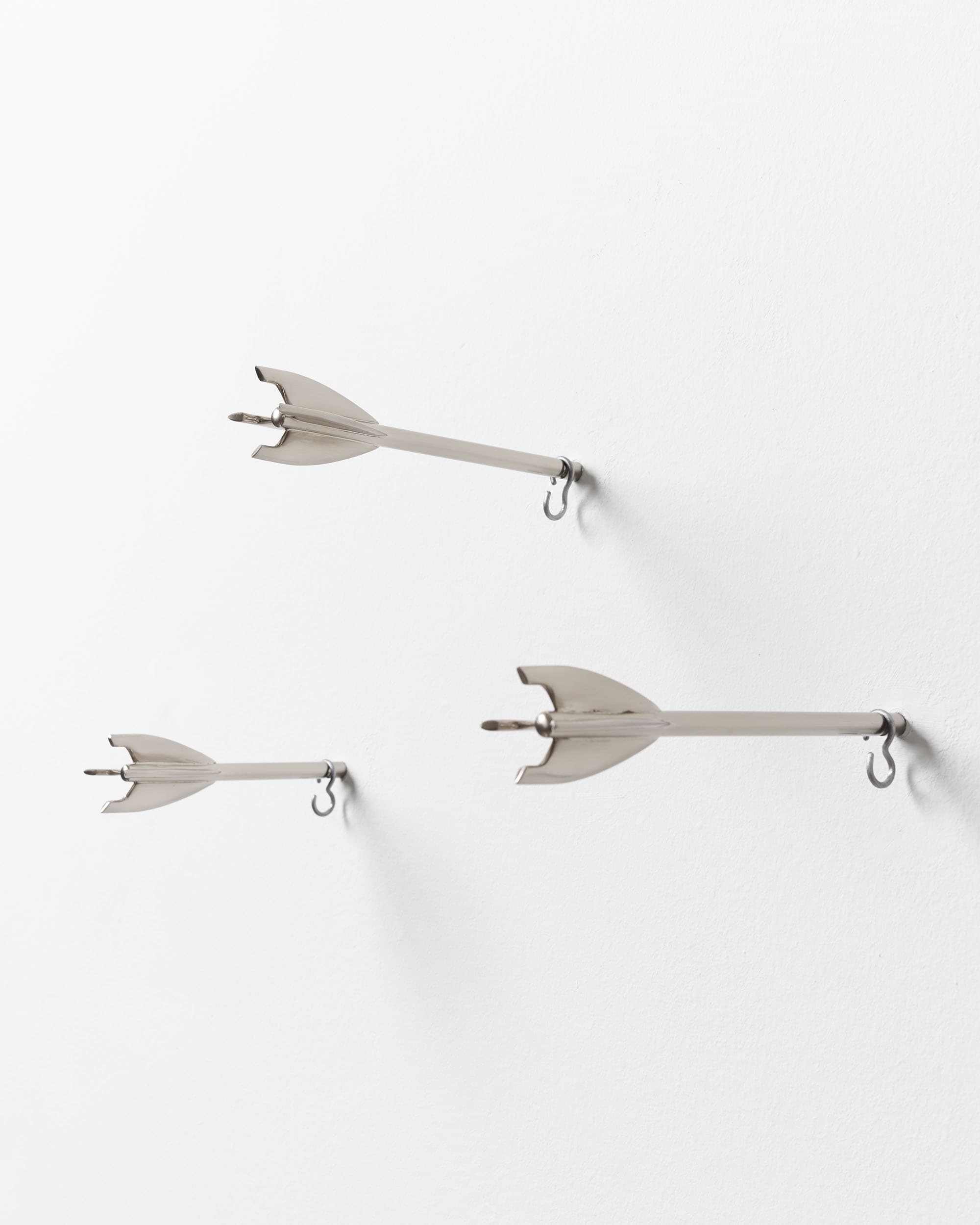 Five Brass Arrow Wall Hooks - image 8 - side view of the arrow hooks embedded in wall