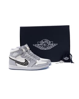 Dior x Air Jordan 1 High Sneakers - image 9 - sneakers next to branded AIR DIOR packaging and original Air Jordan charm