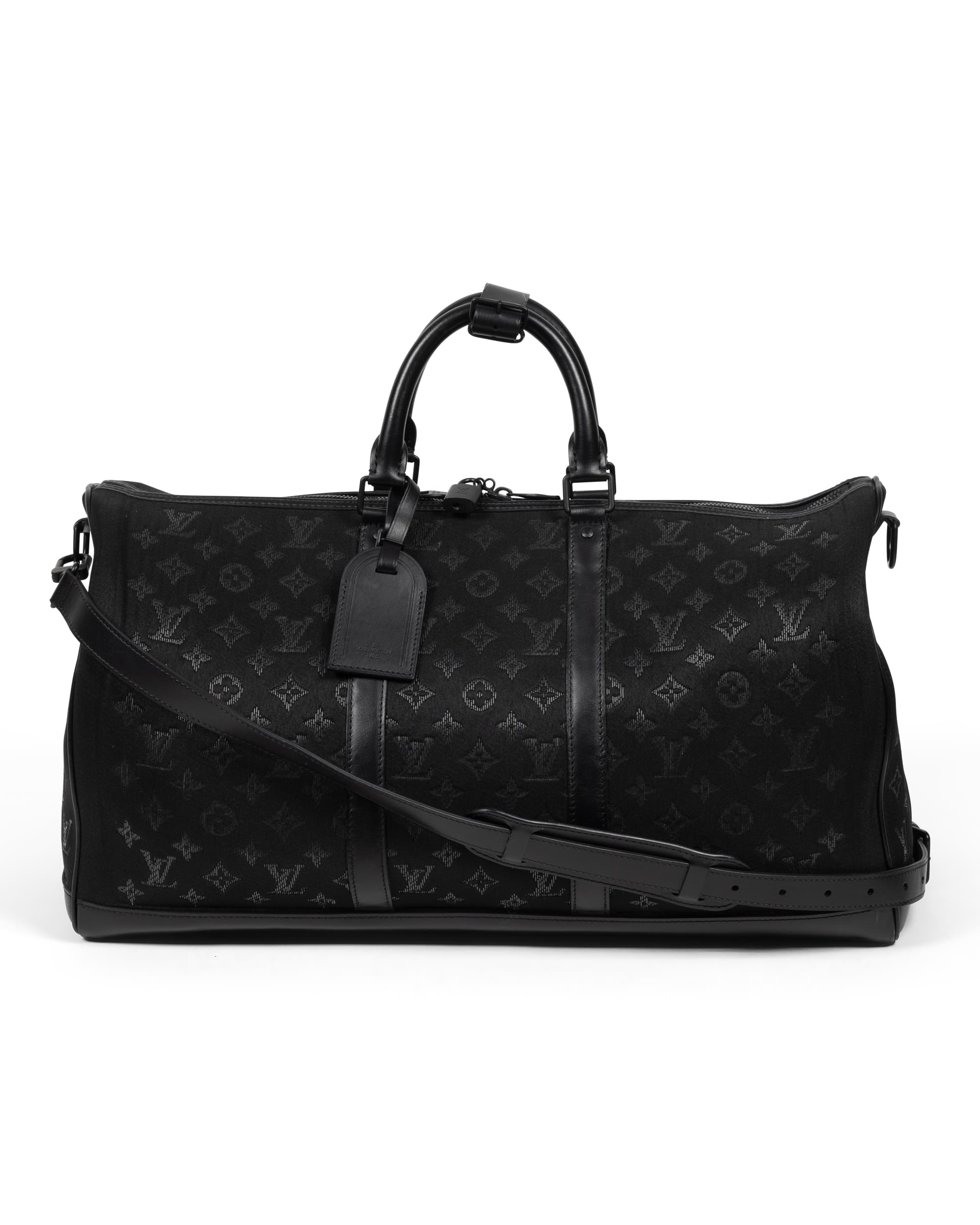 Black Light Up Keepall Bandoulière 50 - image 2 - back of bag showing the black embossed material, carrying strap and luggage label