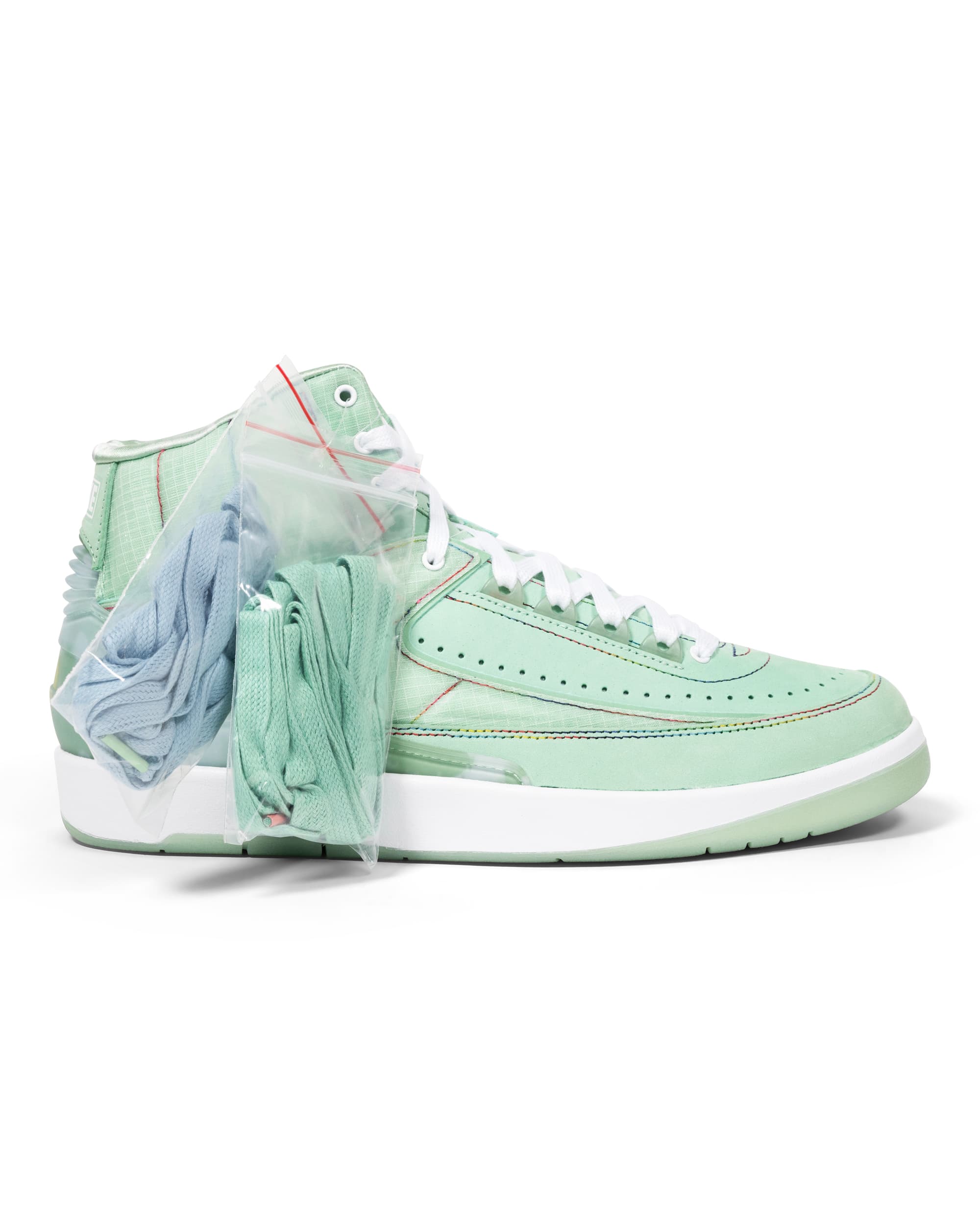 Retro Friends & Family Sample Sneakers - image 4 - side of shoe with 2 clear packets containing extra green and blue laces.